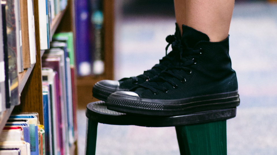 black high-top sneakers on a stool